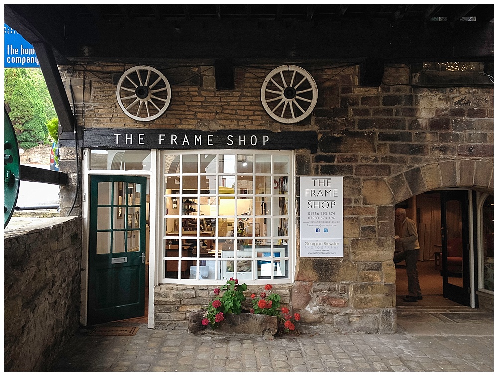Historic frame shop entrance with stone facade and green door
