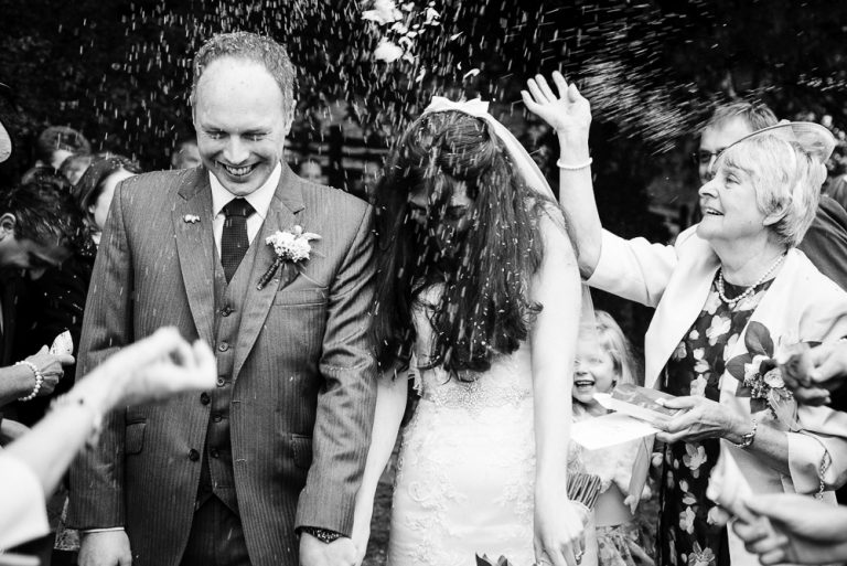 Joyful wedding celebration with confetti and smiling guests