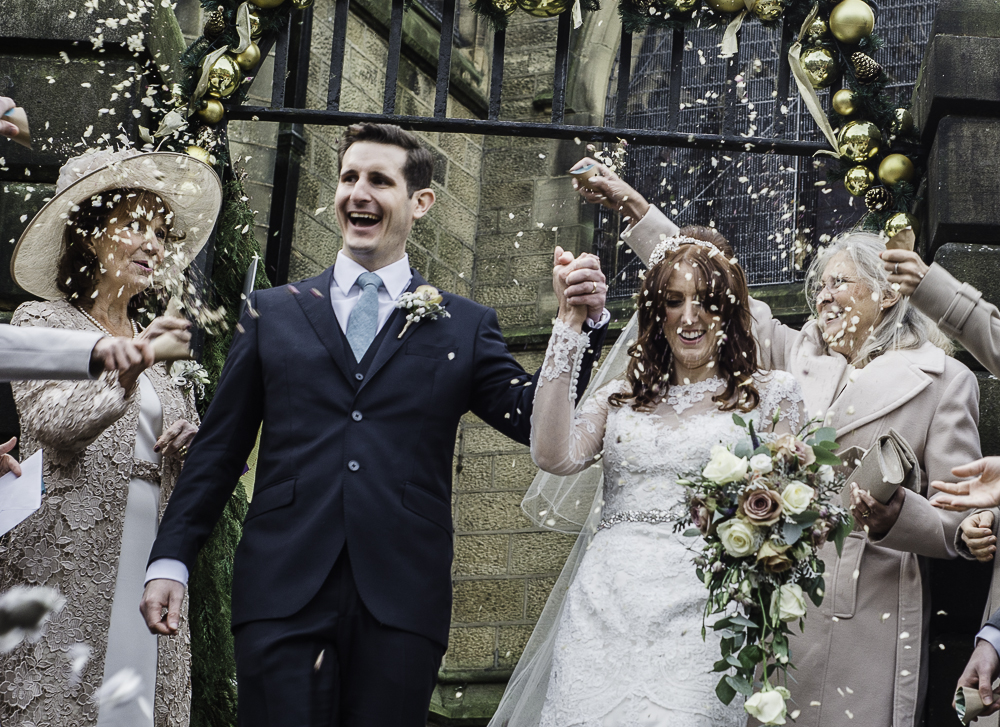 Happy couple celebrates wedding with confetti and flowers