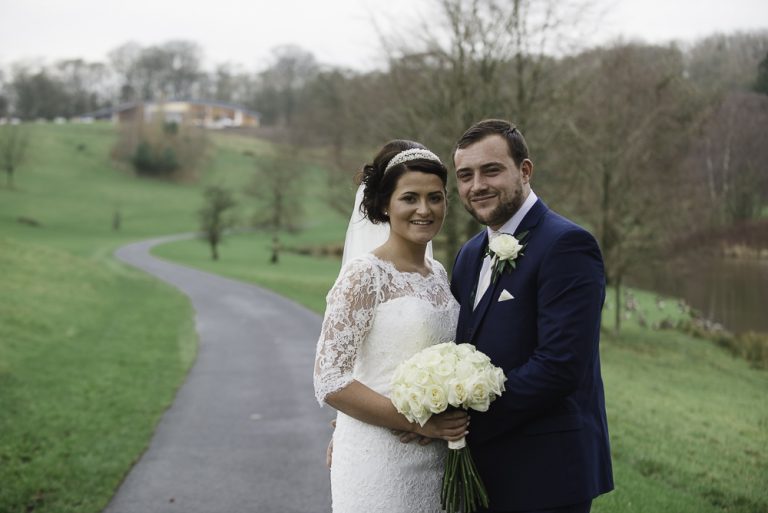 Bride and groom in a park on their wedding day.