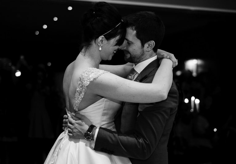 Bride and groom share a romantic first dance at their wedding