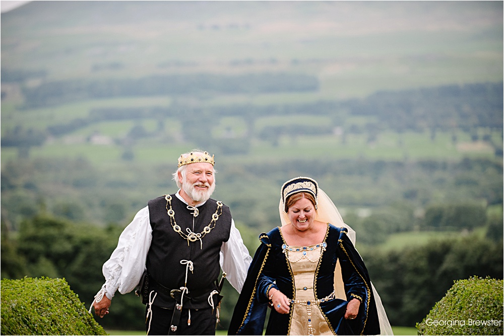 Medieval themed couple walking in lush green landscape