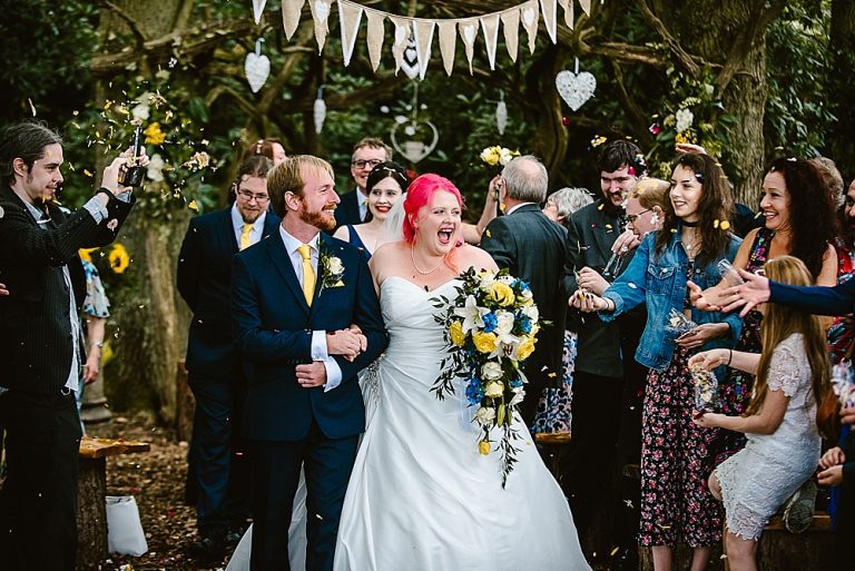 Bride and groom celebrating at vibrant outdoor wedding ceremony