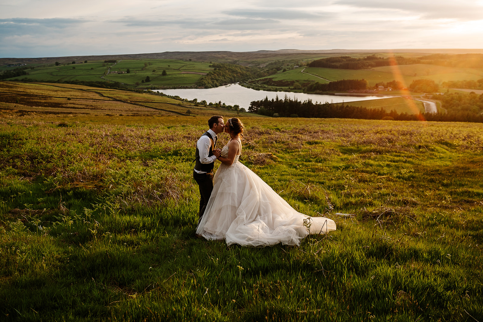 Swinton estate wedding Bride and groom kissing in sunset countryside landscape