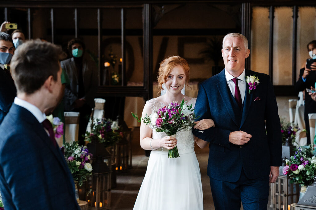 Bride walking down the aisle with father at wedding ceremony The Priests House in Barden, North Yorkshire
