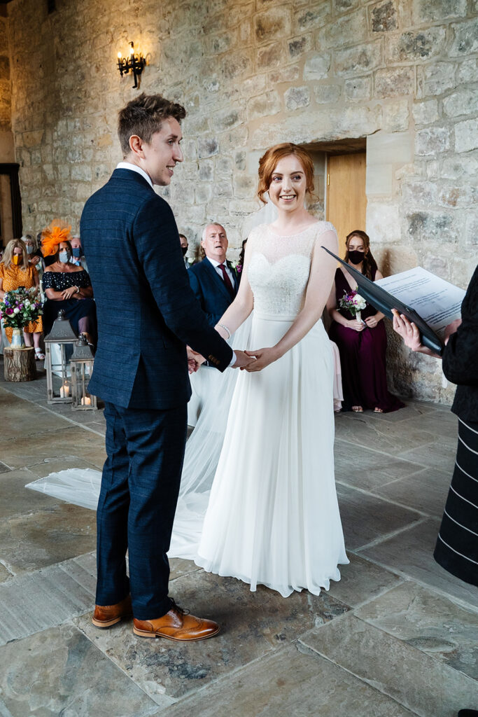 Bride and groom exchanging vows in a beautiful stone venue The Priests House in Barden, North Yorkshire