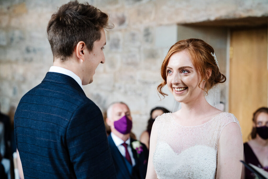 Bride and groom exchanging vows in a wedding ceremony The Priests House in Barden, North Yorkshire