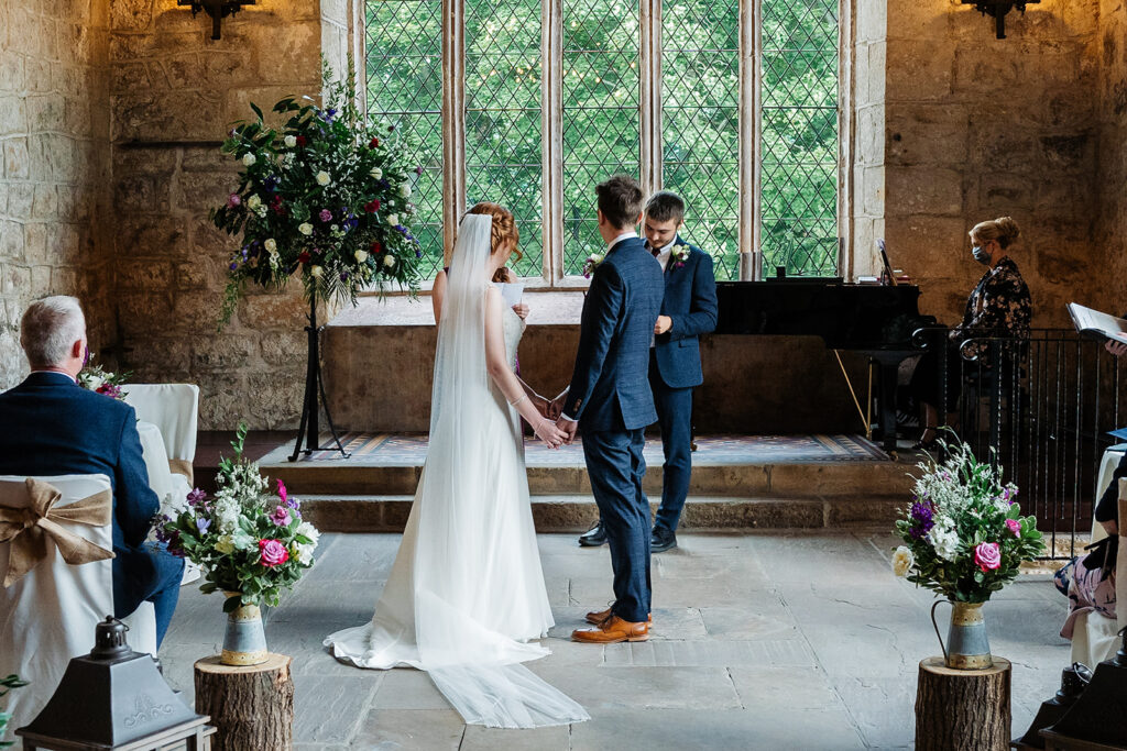 Couple exchanging vows in a charming stone-walled venue The Priests House in Barden, North Yorkshire