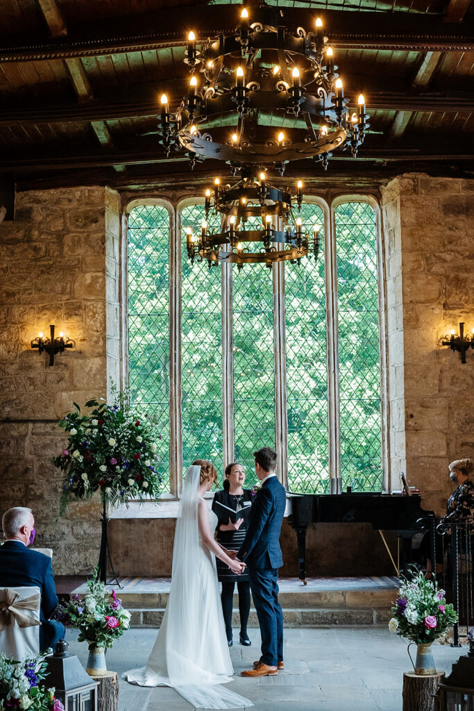 Couple exchanging vows in historic wedding venue interior The Priests House in Barden, North Yorkshire