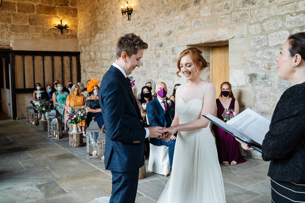 Bride and groom exchange vows at indoor wedding ceremony The Priests House in Barden, North Yorkshire