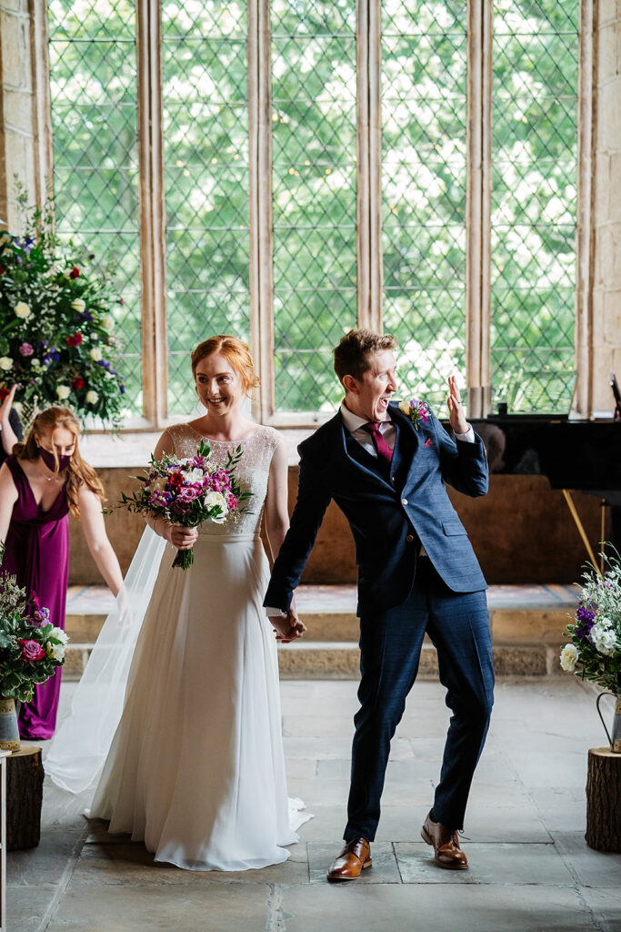 Bride and groom celebrating in a beautiful chapel setting The Priests House in Barden, North Yorkshire