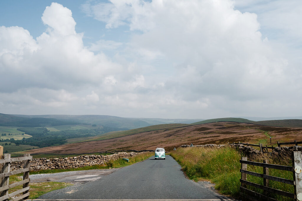 Vintage van travels through scenic countryside landscape The Priests House in Barden, North Yorkshire
