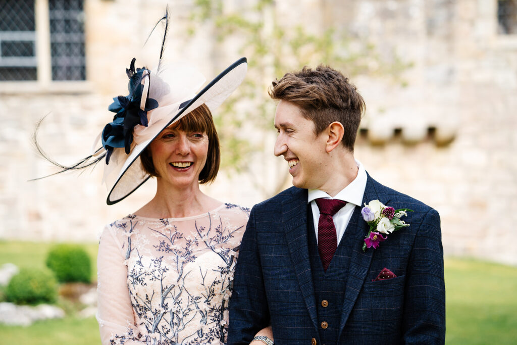 Smiling couple dressed elegantly at a formal outdoor event