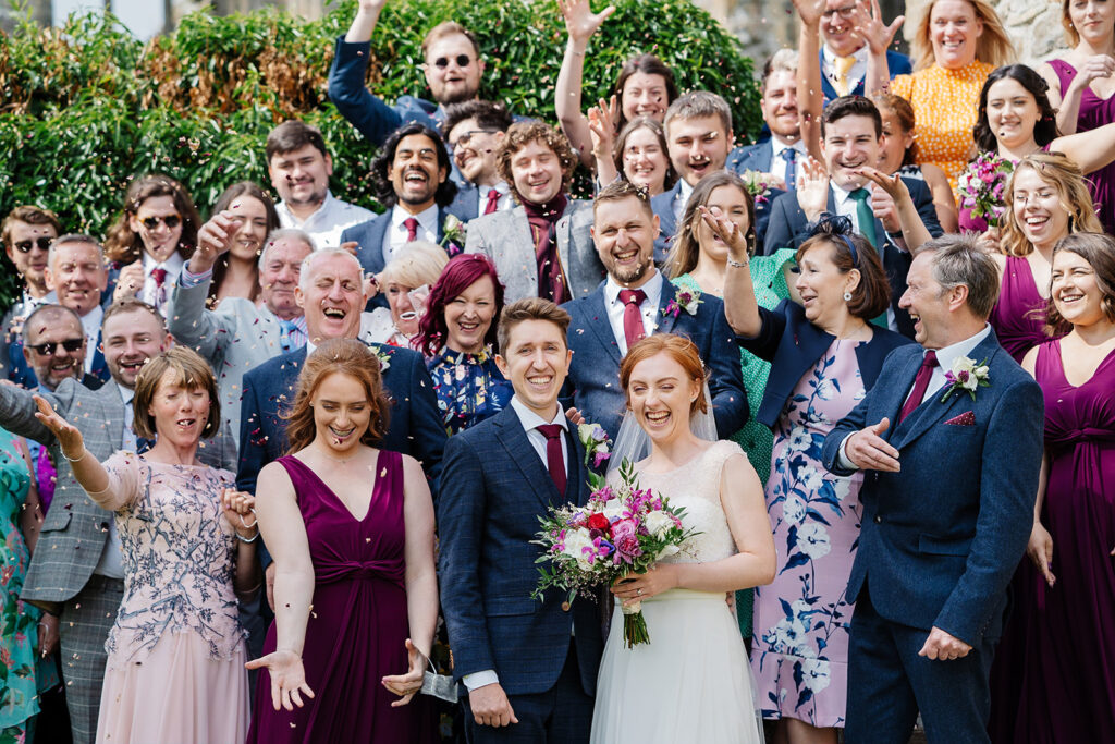 Happy wedding celebration with bride groom and guests smiling