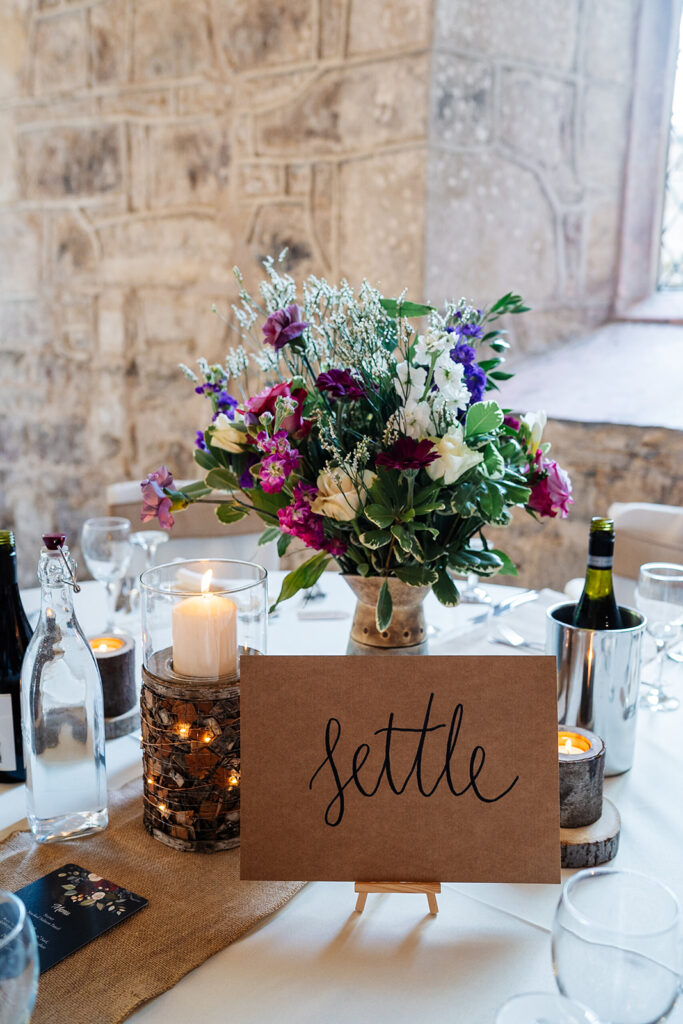 Elegant table decor with flowers and candles at a wedding reception