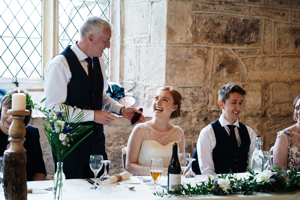 Wedding toast speech at a joyful reception in rustic venue