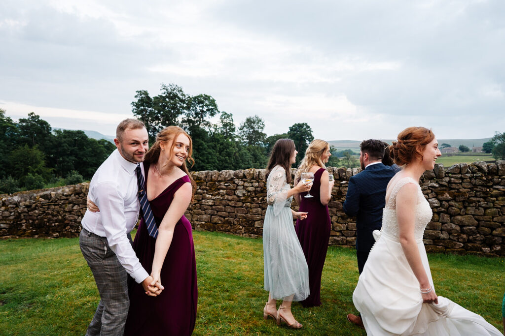 People dancing at an outdoor wedding celebration