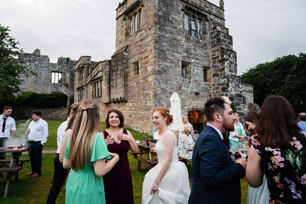 Guests enjoying outdoor wedding at historic stone castle The Priests House in Barden, North Yorkshire