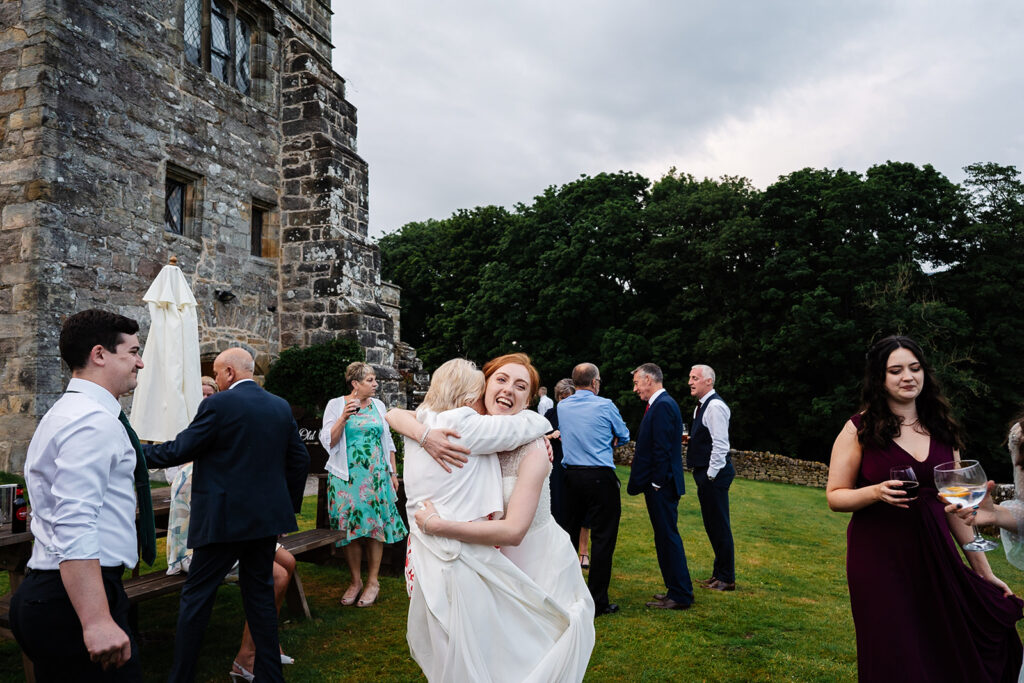 Guests enjoying outdoor wedding reception at historic venue The Priests House in Barden, North Yorkshire