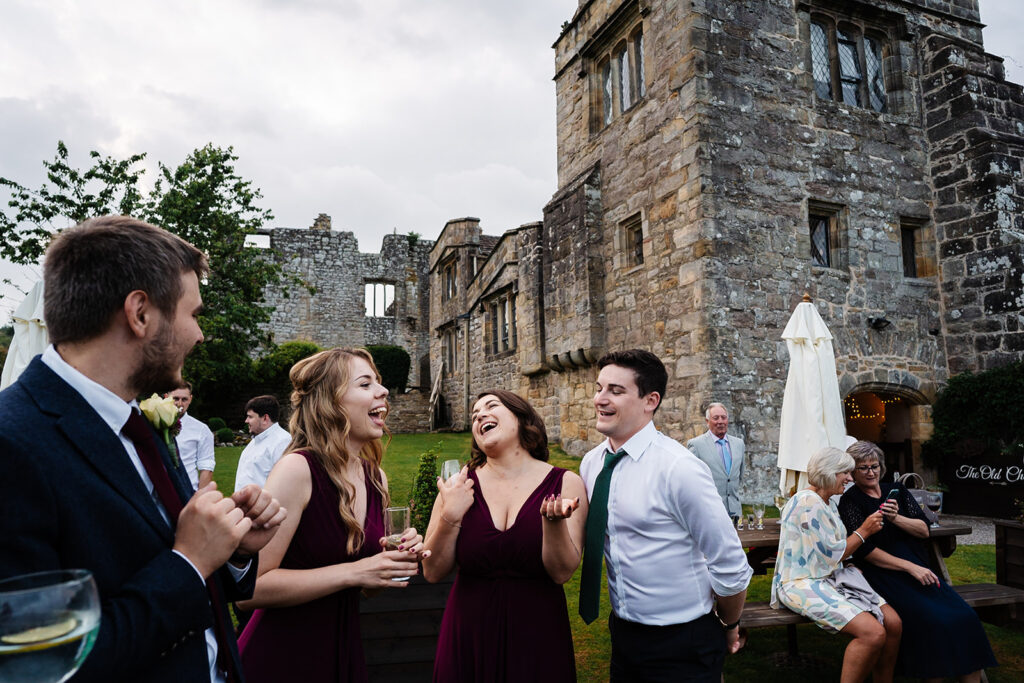 Guests enjoying an outdoor celebration at historic stone venue The Priests House in Barden, North Yorkshire