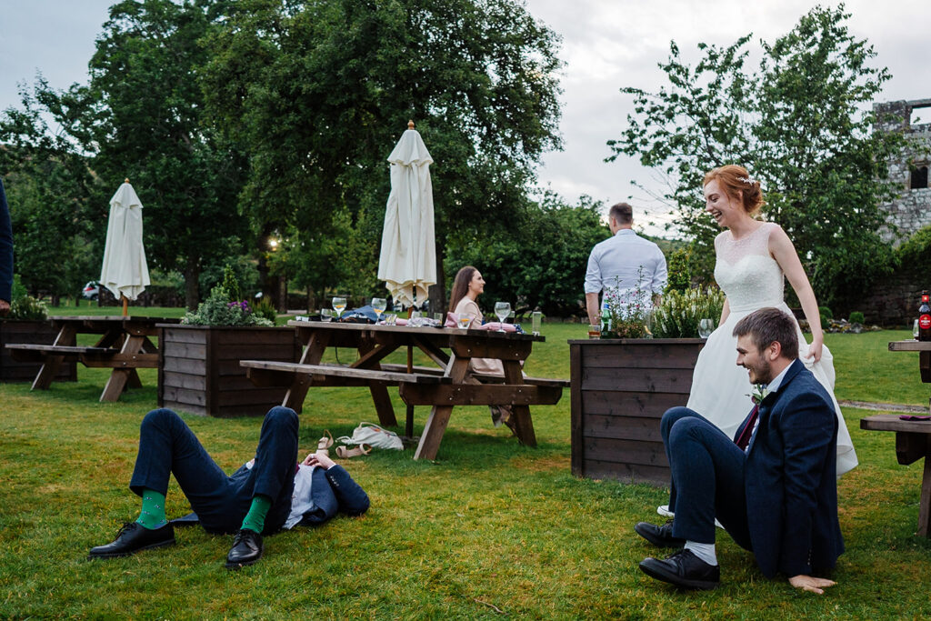 Outdoor wedding celebration with laughter and relaxed guests