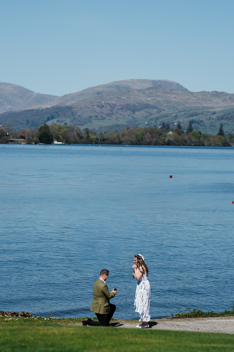 Romantic lakeside proposal with scenic mountain backdrop