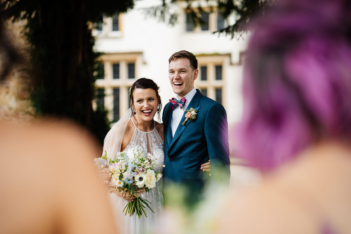 Smiling bride and groom outside on their wedding day
