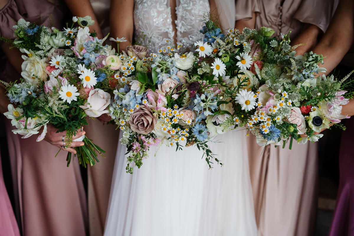 Bridal party holding elegant floral wedding bouquets
