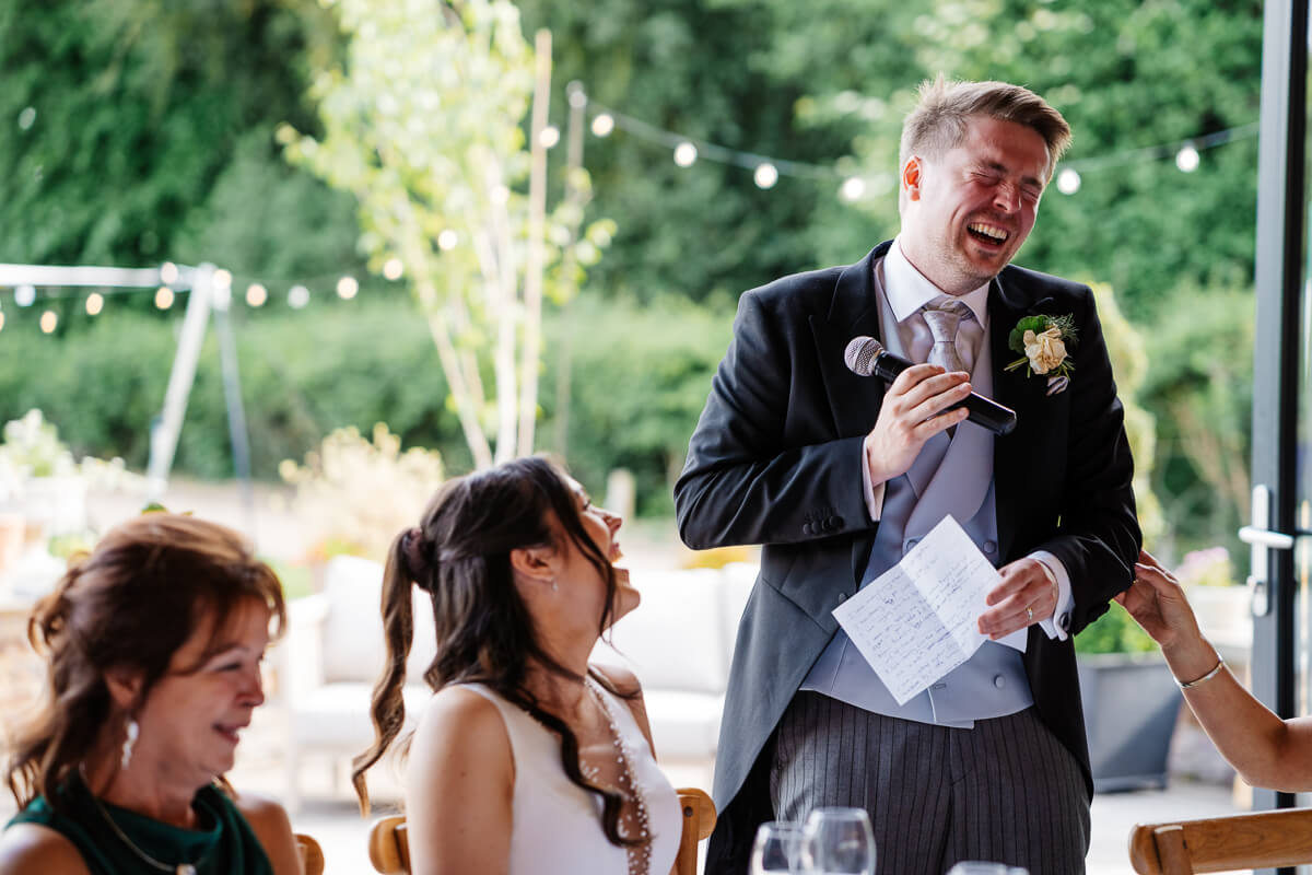 Groom giving a heartfelt speech at a wedding reception