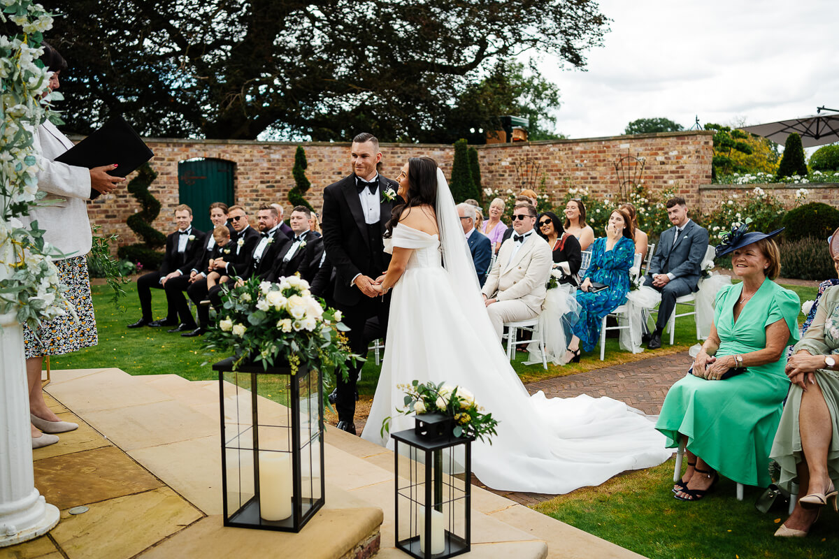 Outdoor wedding ceremony with bride groom and seated guests