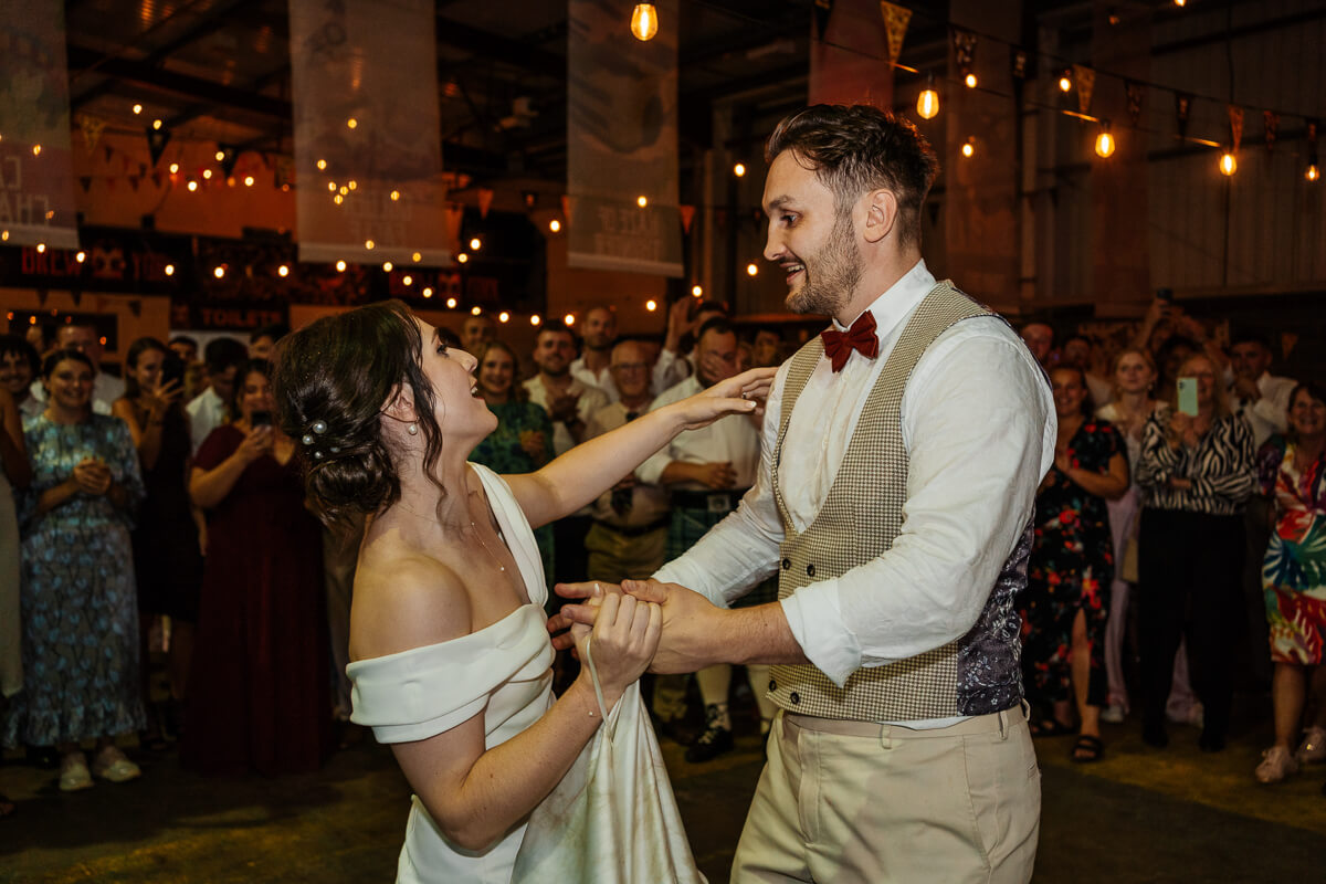 Couple enjoying a joyful dance at their wedding reception