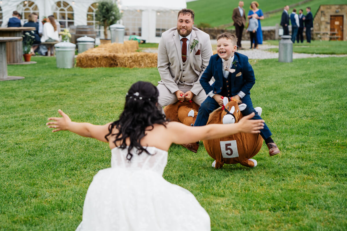 Bride playing games with guests at outdoor wedding reception