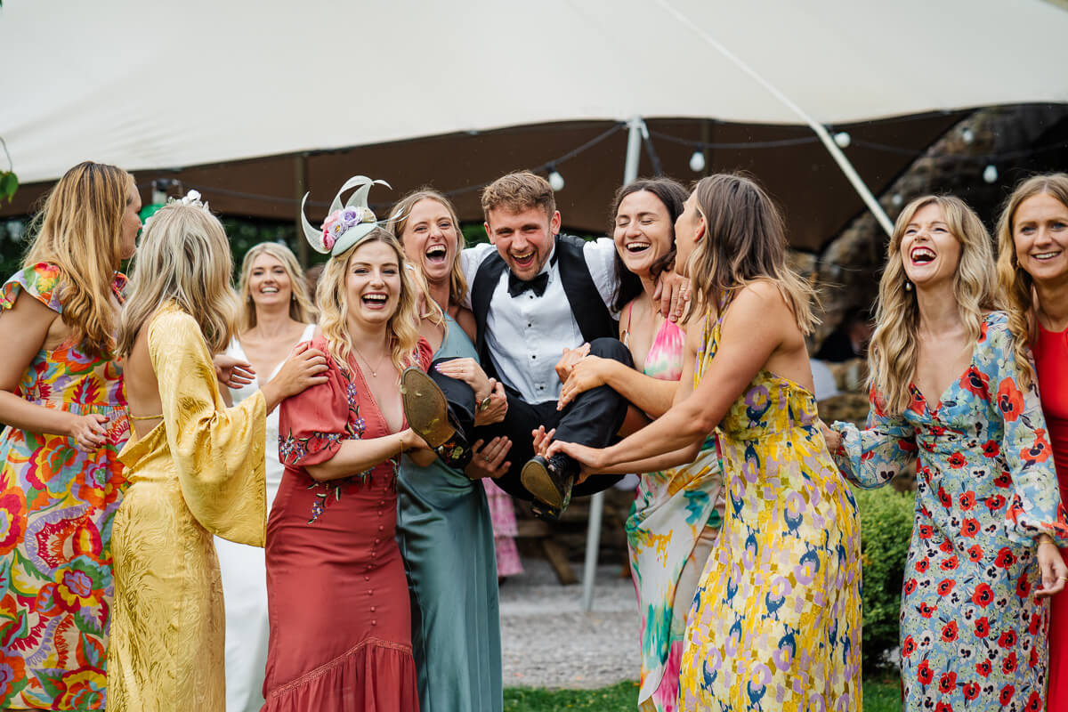 Group celebrating at a joyful summer outdoor wedding party