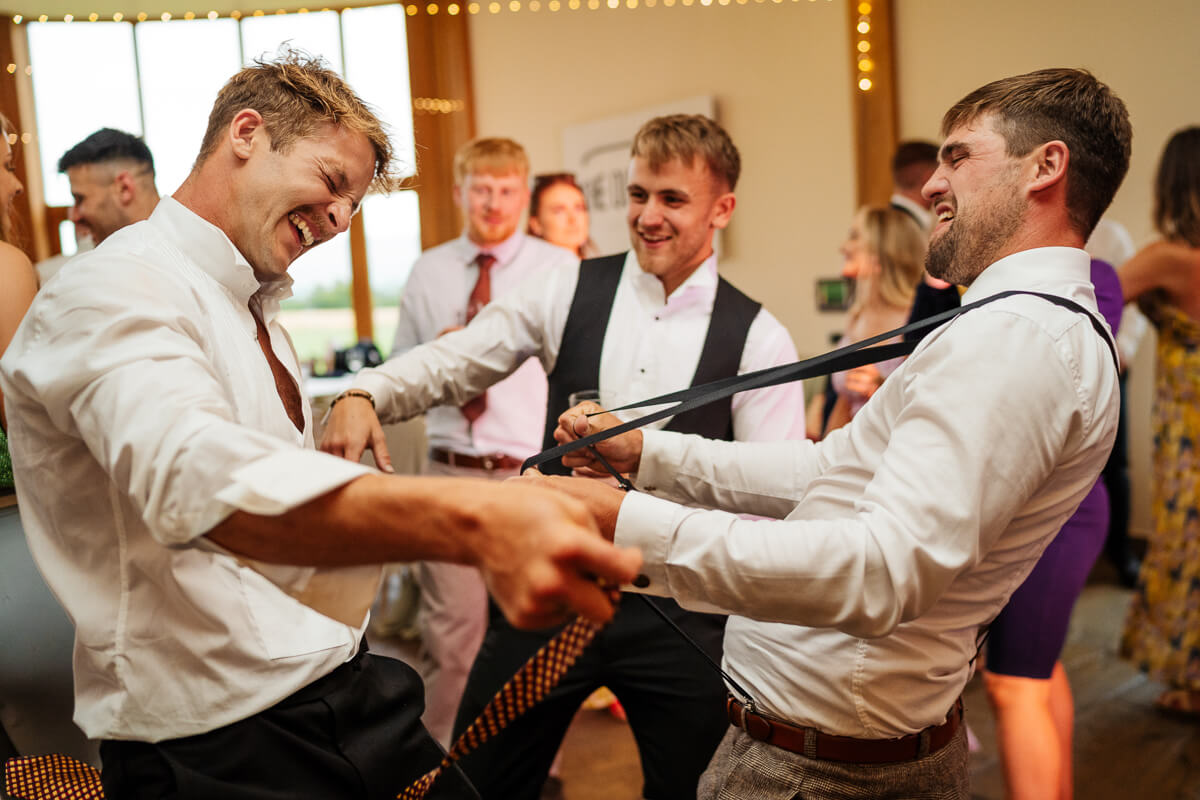 Men joyfully dancing and celebrating at a lively event