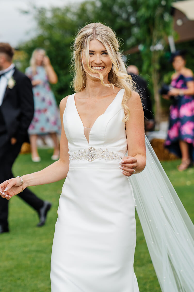 Bride in elegant white gown at outdoor wedding ceremony