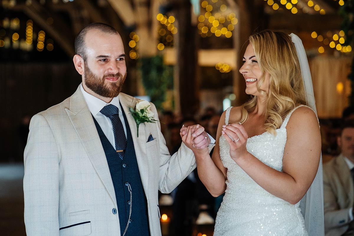 Bride and groom sharing a joyful moment at wedding ceremony