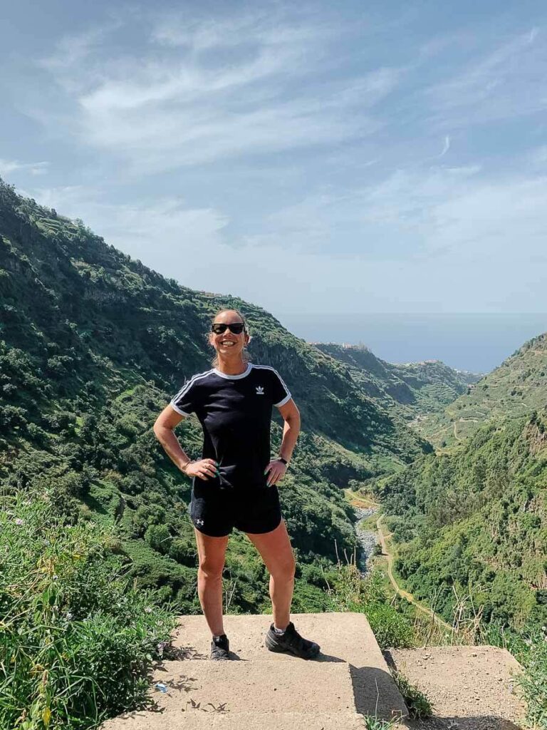 Person enjoying a scenic mountain view on a sunny day